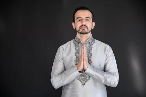 Man Wearing Traditional Clothes Praying