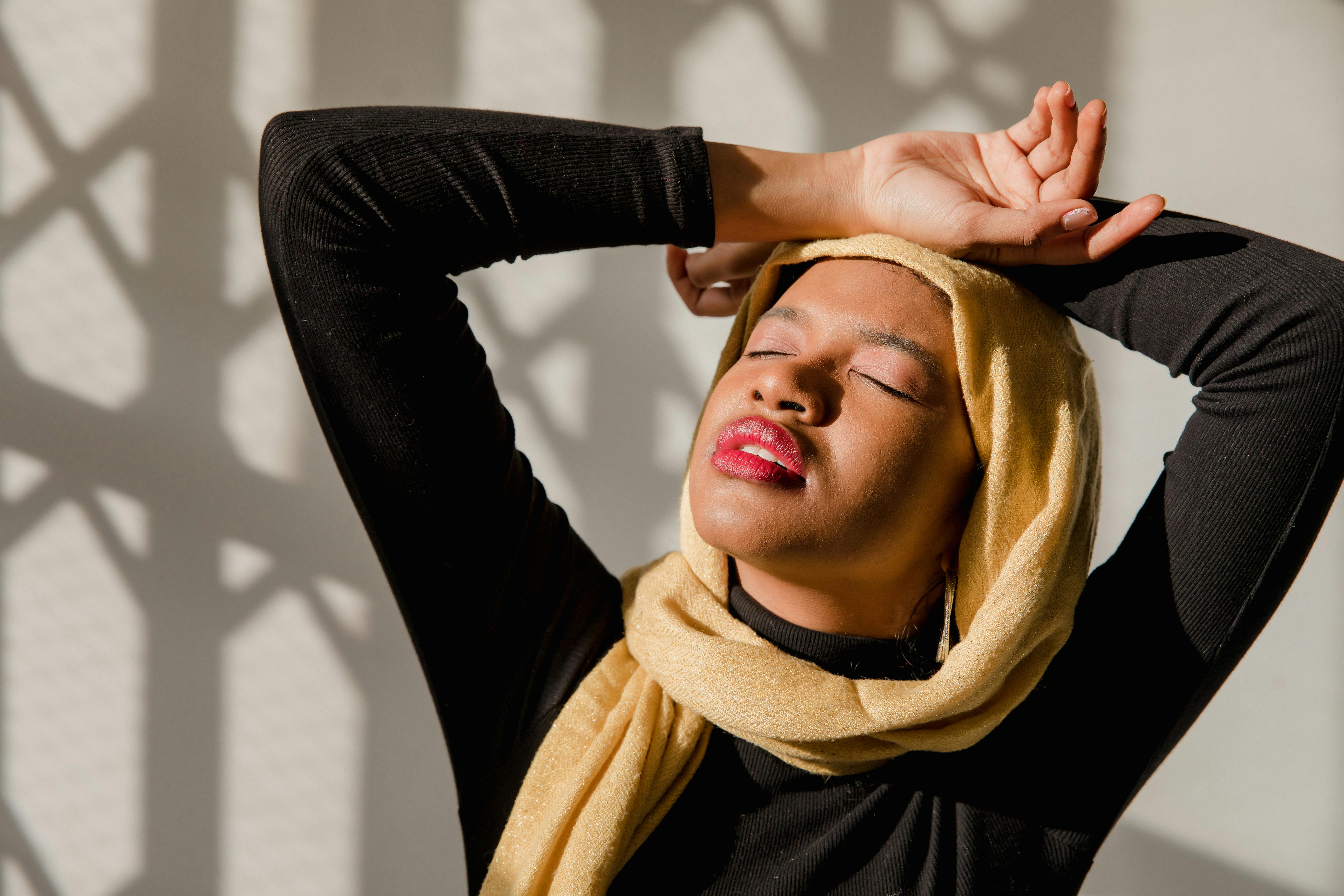 Woman in Black Long Sleeve Shirt Wearing Brown Hijab