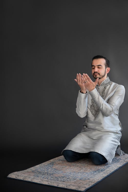 Man in Gray Long Sleeve Shirt Kneeling