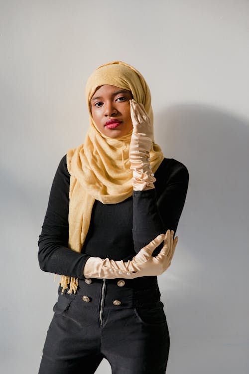 Woman in Black Long Sleeve Shirt Wearing Yellow Hijab
