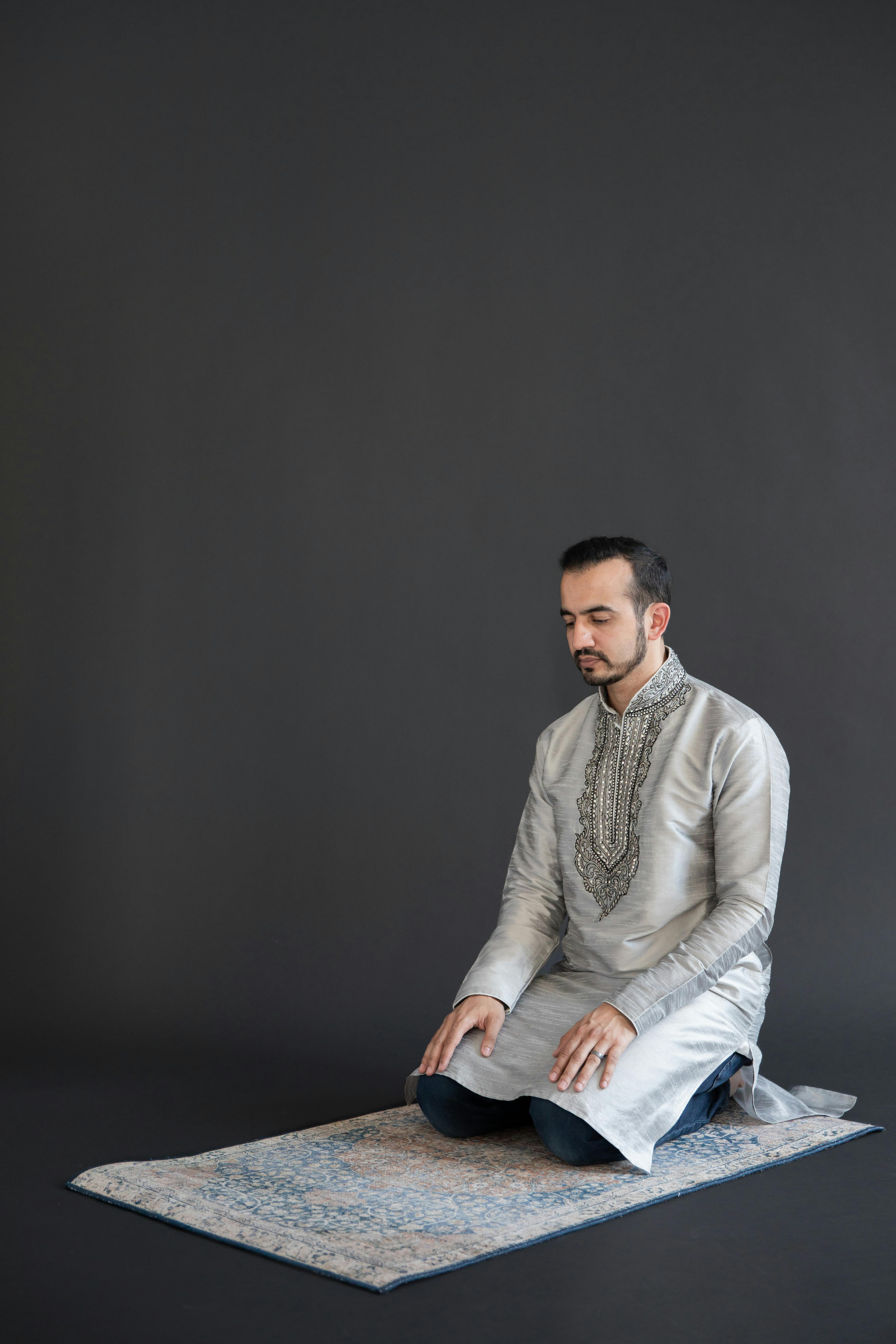 man kneeling on a carpet