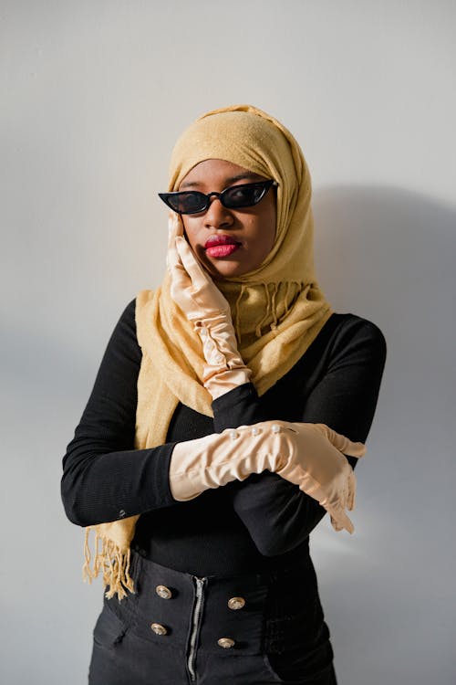 Woman in Black Long Sleeve Shirt Wearing Yellow Hijab and Black Sunglasses