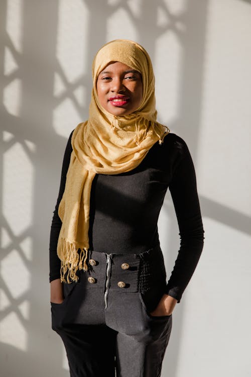 Woman in Black Long Sleeve Top Wearing Yellow Hijab