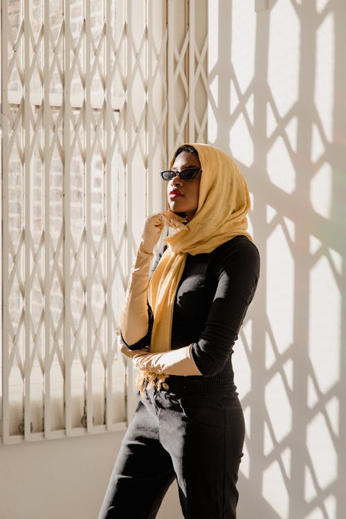 Woman in Black Long Sleeve Shirt and Black Denim Jeans Wearing Black Sunglasses