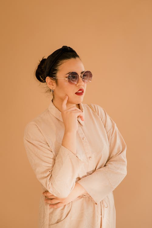 Woman in Cream Long Sleeve Wearing Sunglasses