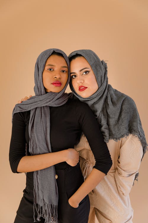 Woman in Black Long Sleeve Shirt and Gray Hijab Beside Another Woman Wearing Hijab