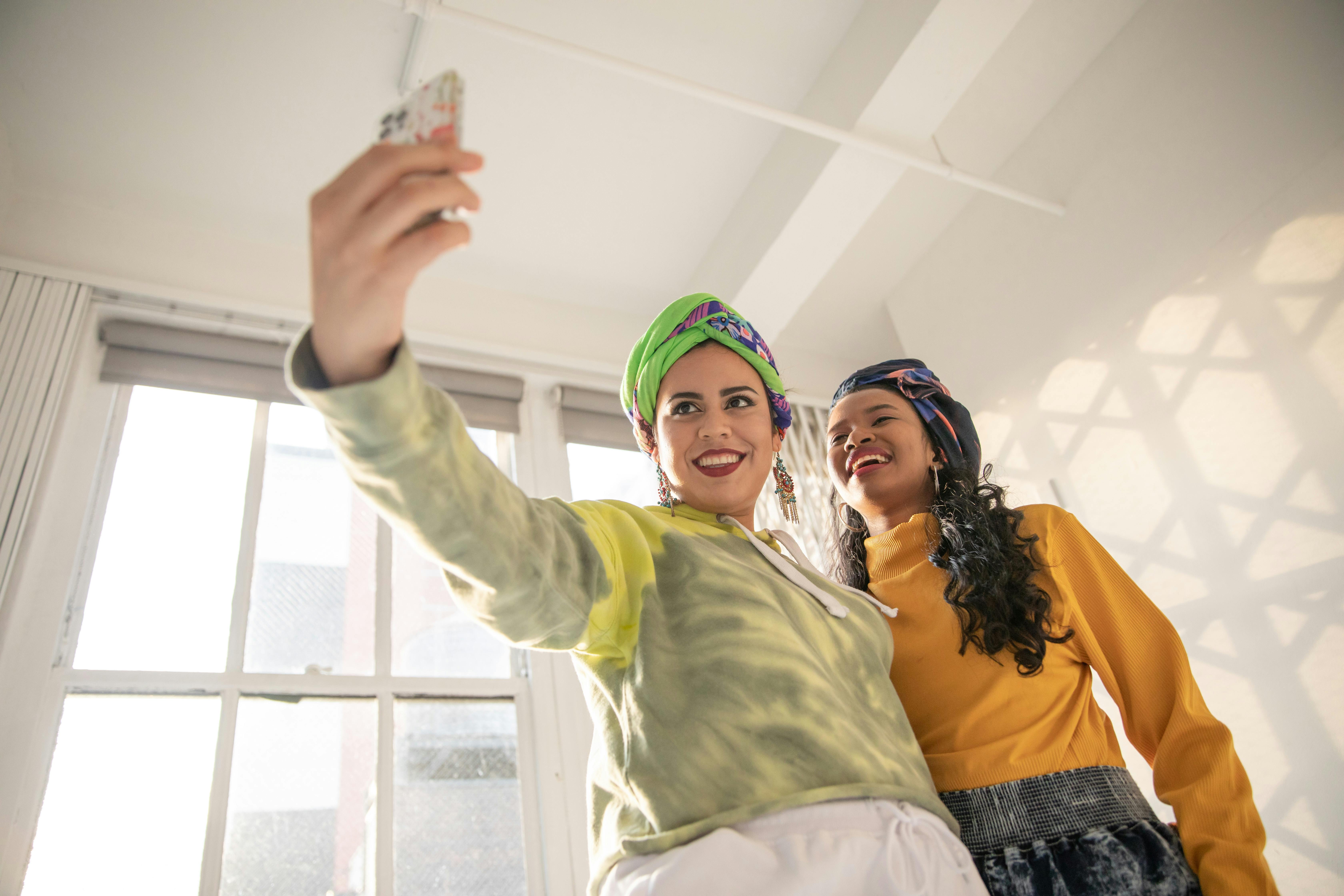 Woman in Green Long Sleeve Shirt and Blue Denim Jeans
