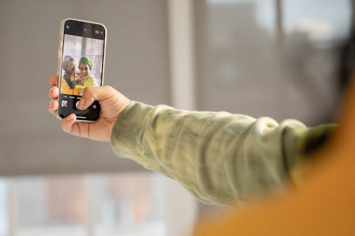 Person Holding Iphone 6 Taking Photo of Building