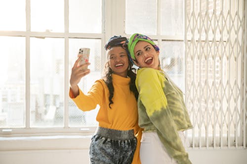 Women Taking a Selfie Near a Window