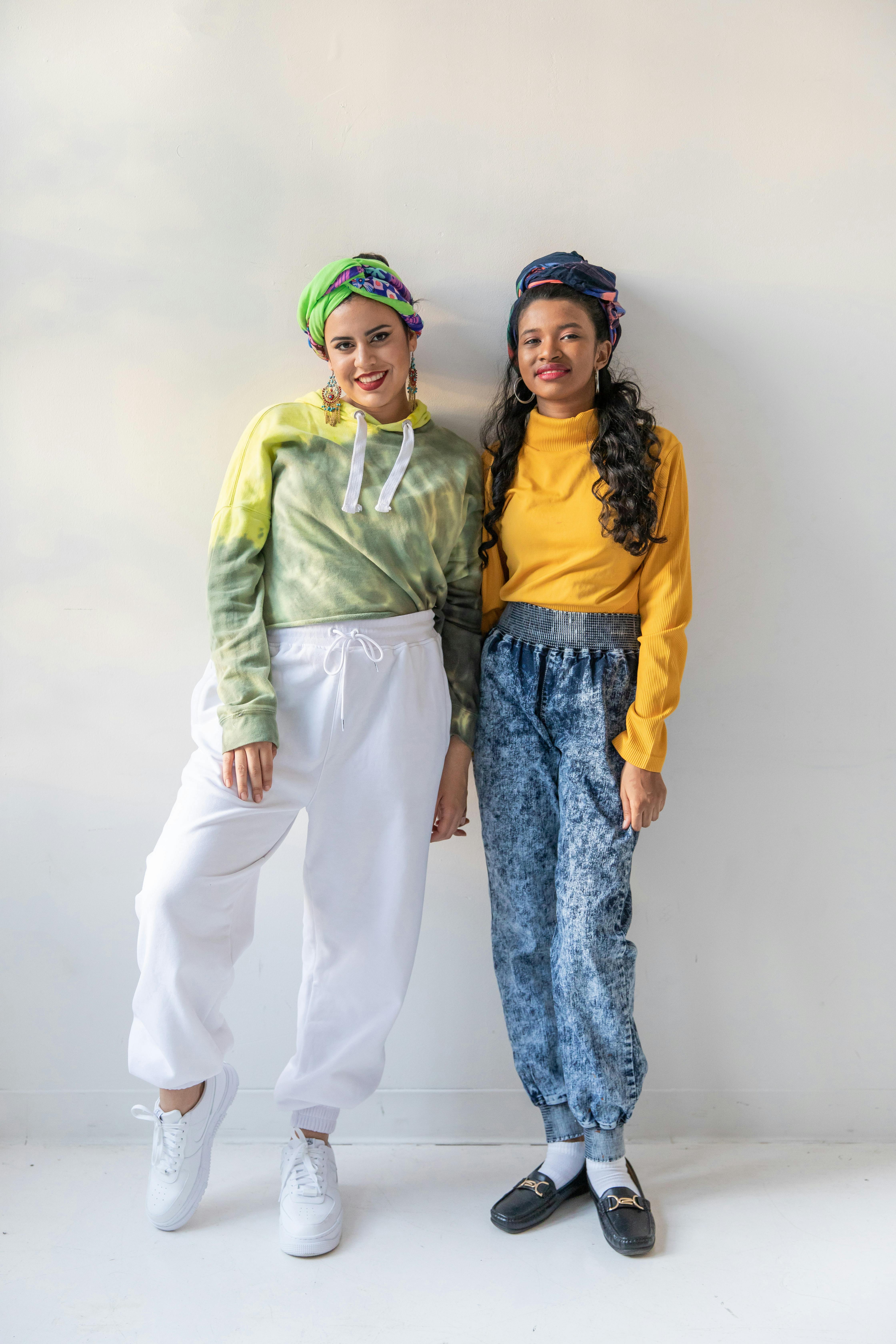 Man in Green Jacket Standing Beside Woman in Yellow Scarf
