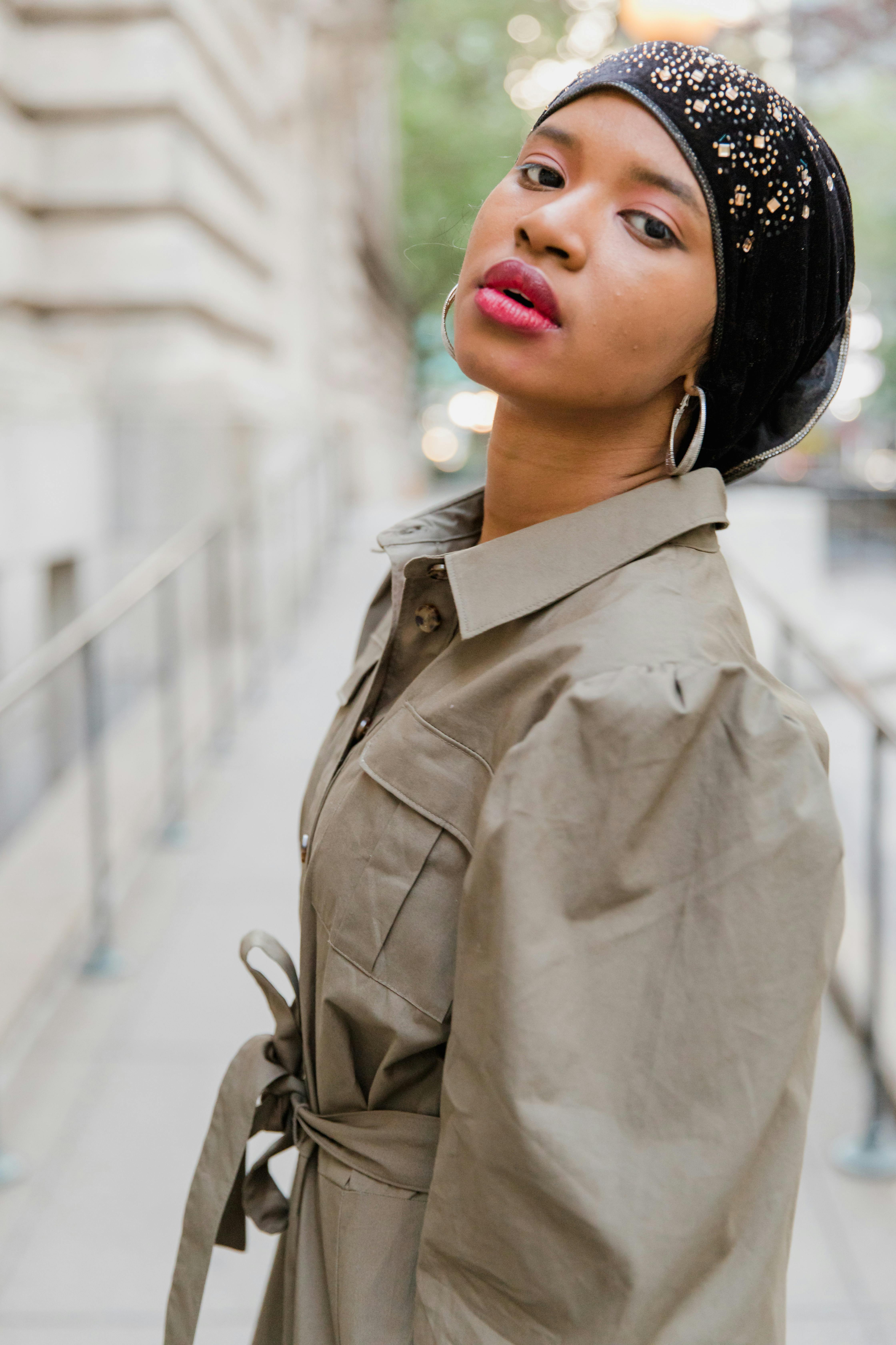 Woman in Grey Coat Wearing Black Headphones