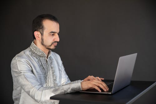 Free Man Using Black Laptop Computer Stock Photo