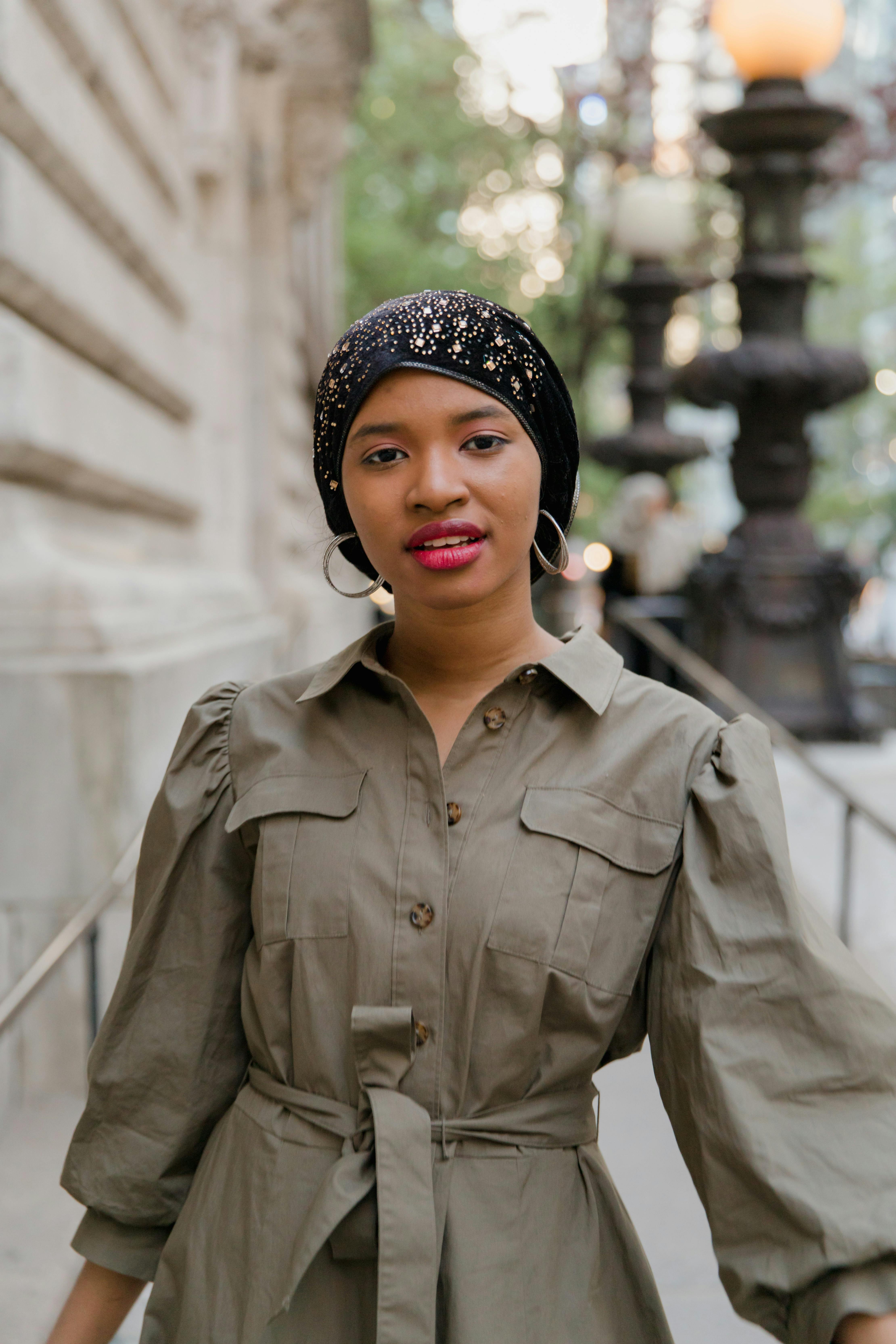 Woman in Gray Coat Wearing Black and White Floral Bandana