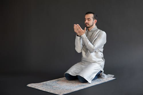 Man Wearing Traditional Clothes Praying