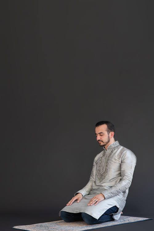 Man Wearing Traditional Clothes Kneeling