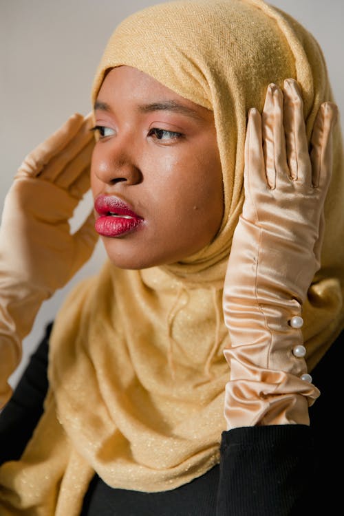 Woman Wearing Yellow Hijab and Silk Gloves