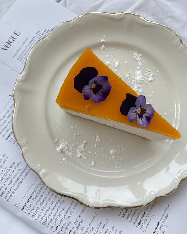 Photo of a Slice of Cheesecake with Flowers