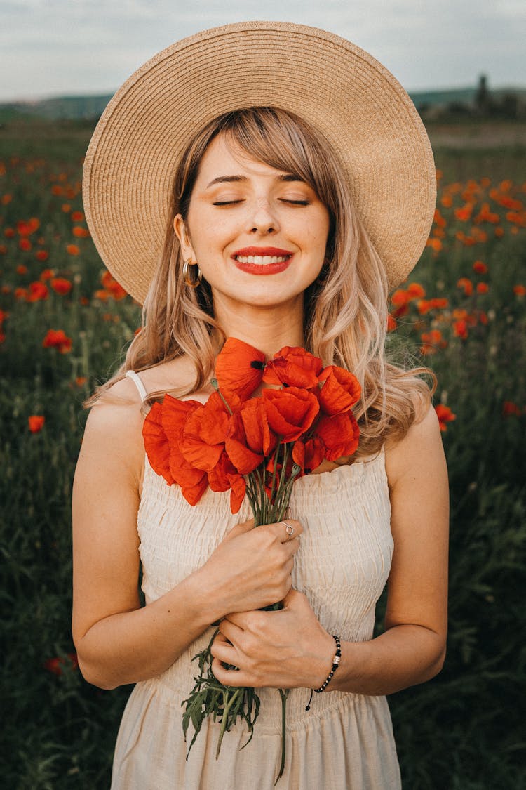 Smiling Female With Bouquet Of Poppy Flowers