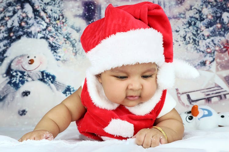 Close Up Of A Baby In A Christmas Outfit