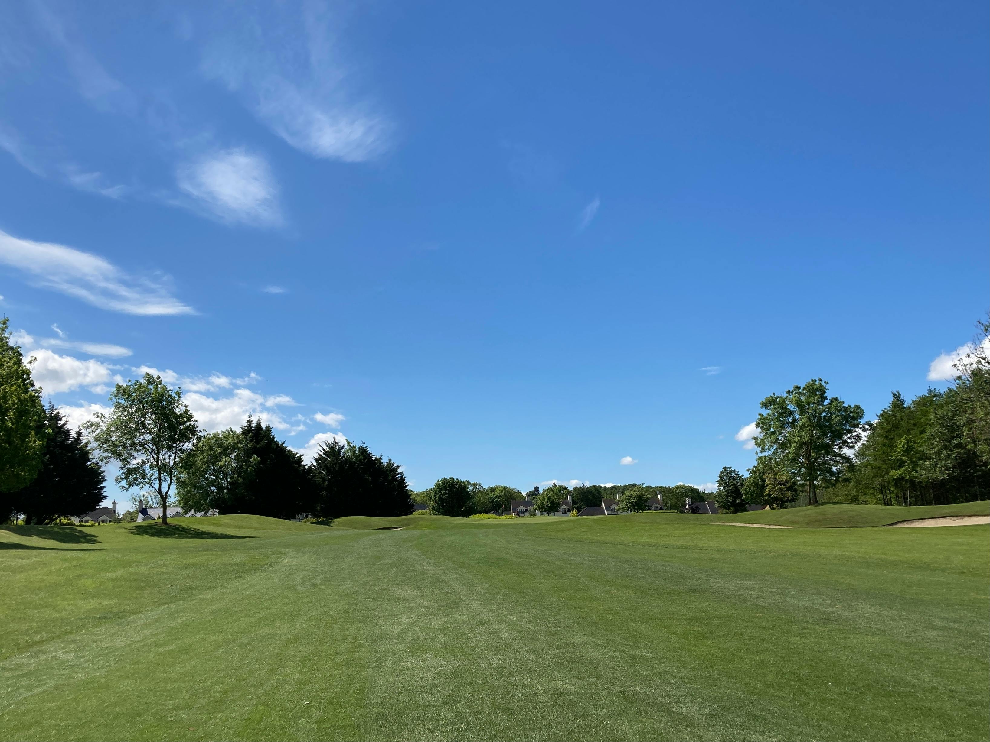 Explore a lush green golf course under a bright blue sky in Dublin.