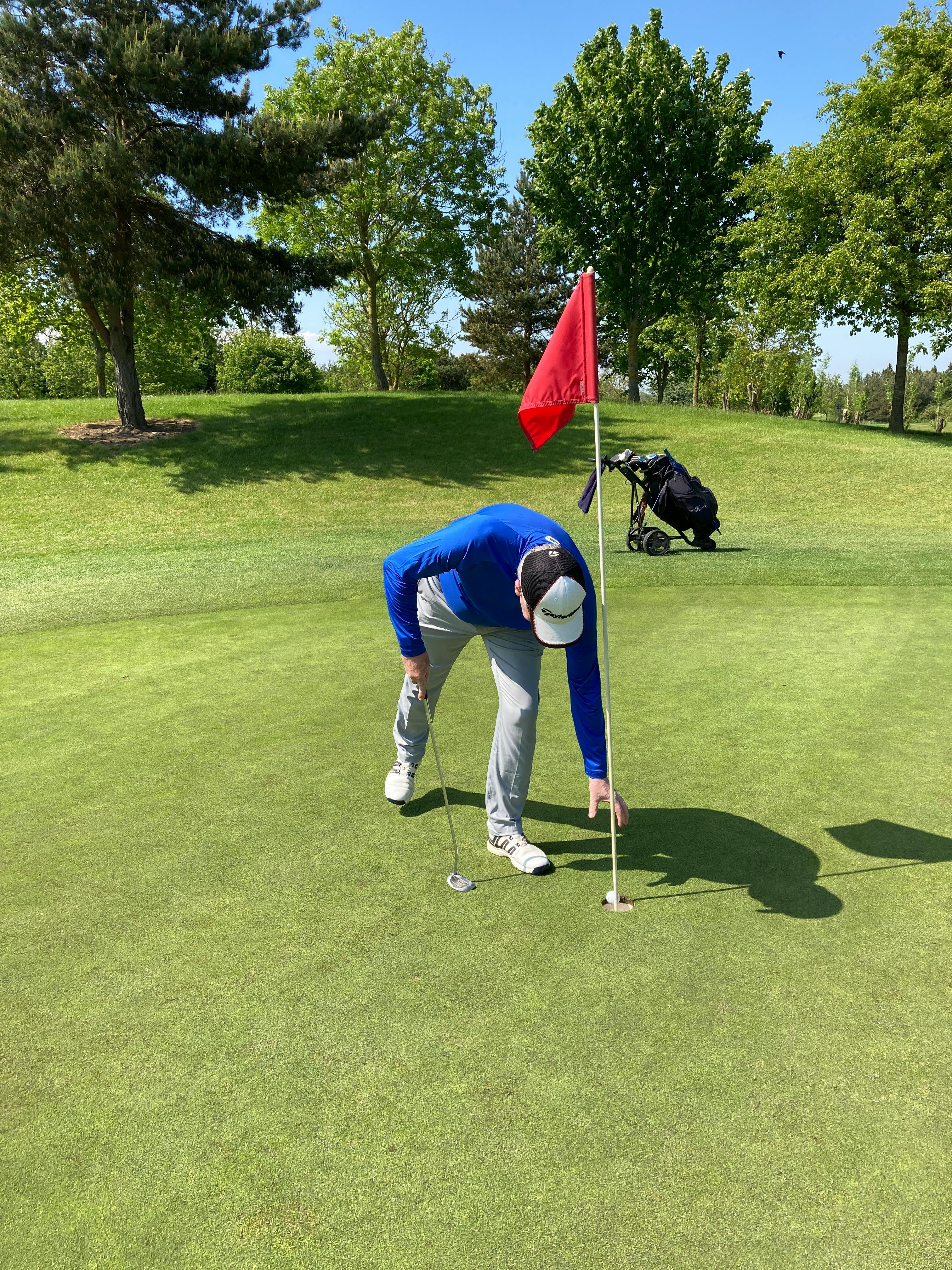 person playing golf on the green