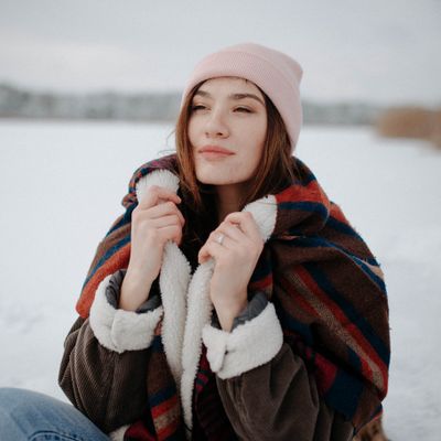 Person in a knitted scarf and shearling coat — Danik Prihodko on Pexels