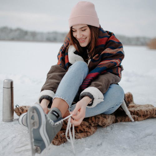Photo of a Woman Putting on Ice Skating Shoes
