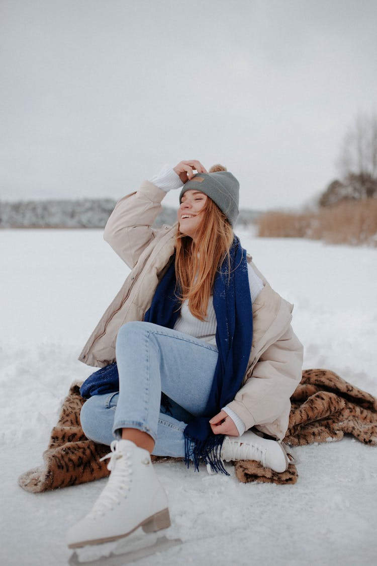 Photo Of A Woman With A Blue Scarf Posing With Her Hand On Her Head