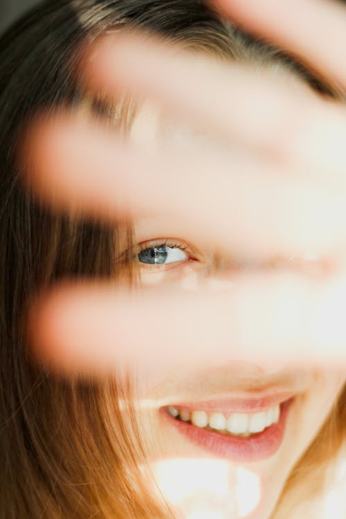 Young Woman Covering Her Face With Her Hands