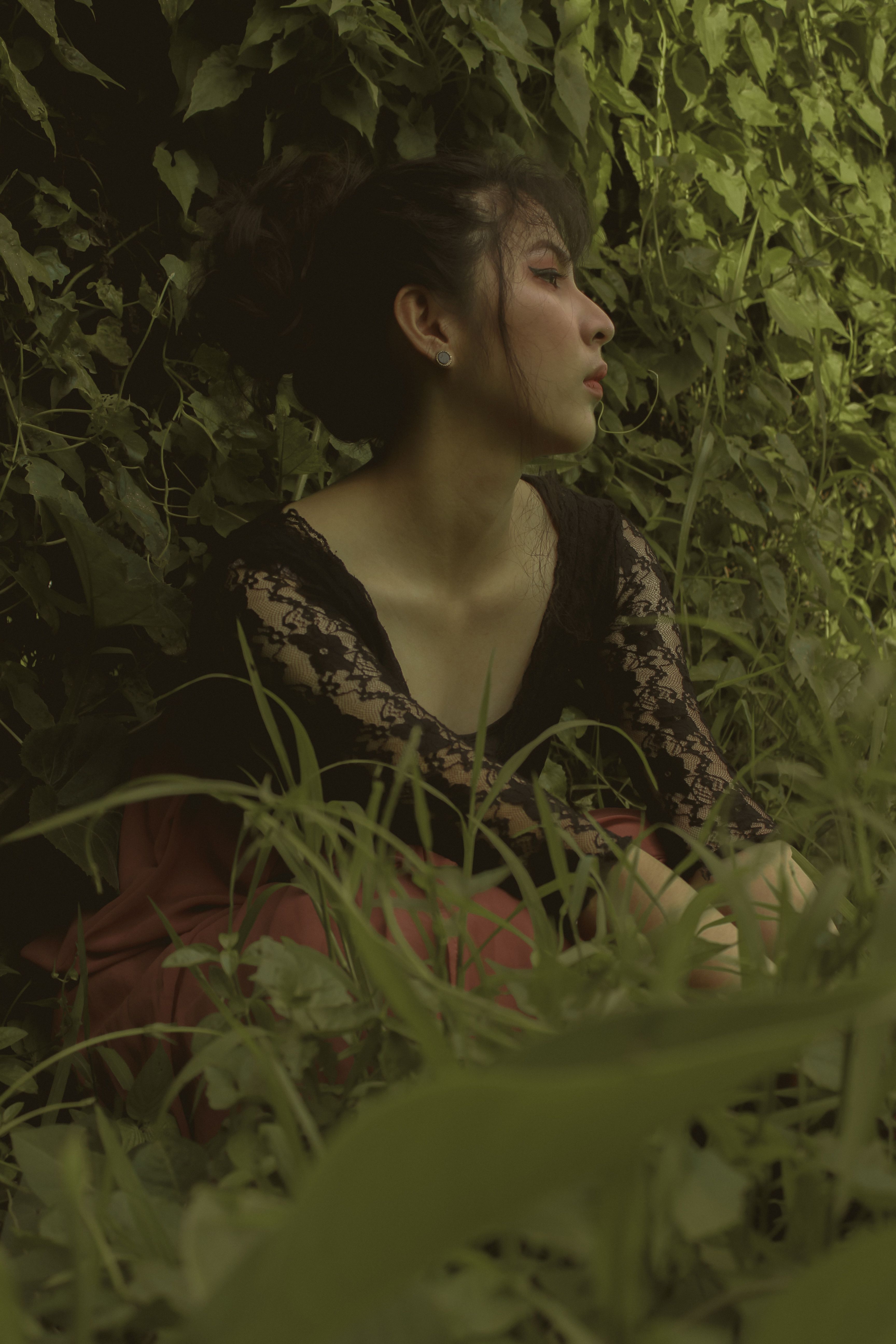 A Woman in Black Dress Sitting on Grass Field · Free Stock Photo