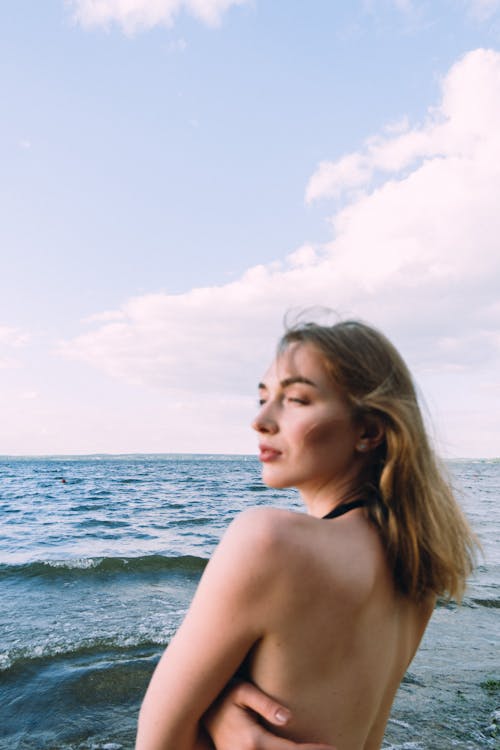 Topless Woman Standing on Sea