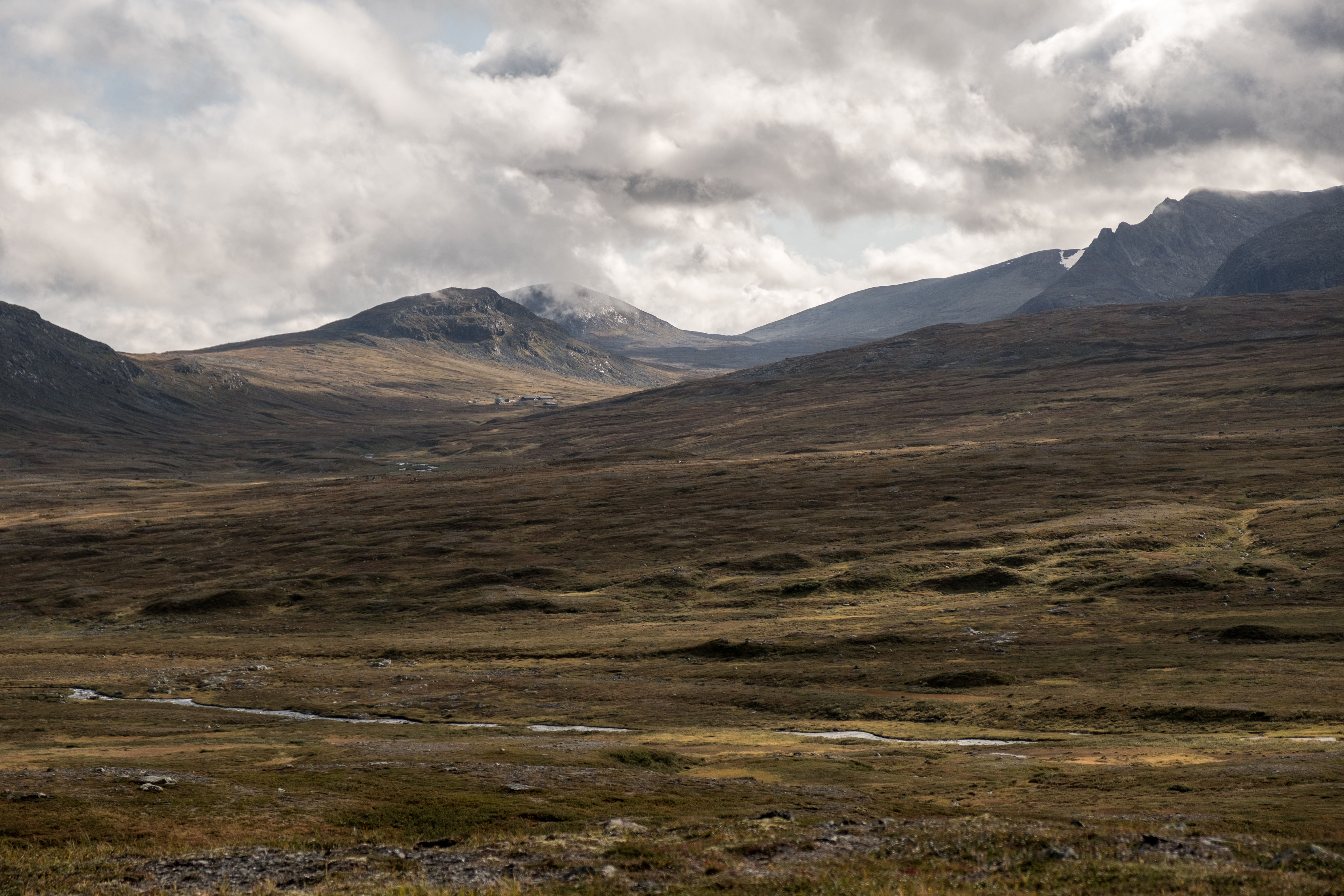 Expansive mountainous landscape under dramatic skies in Jämtlands län, Sweden.