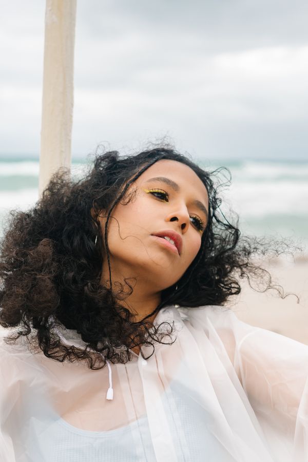 Portrait against open water — photo by Mikhail Nilov on Pexels