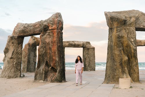 A Woman Walking by Sculptures at Z City Beach