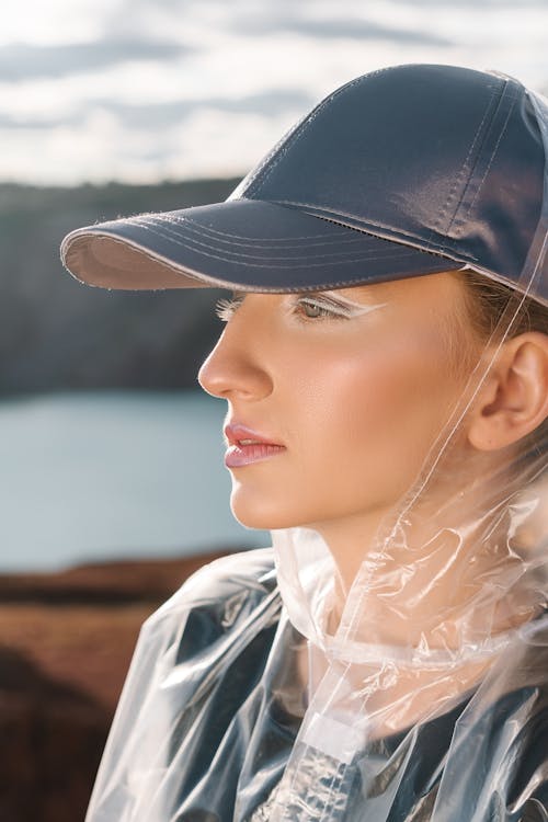 Woman in Black Cap and Clear Raincoat 