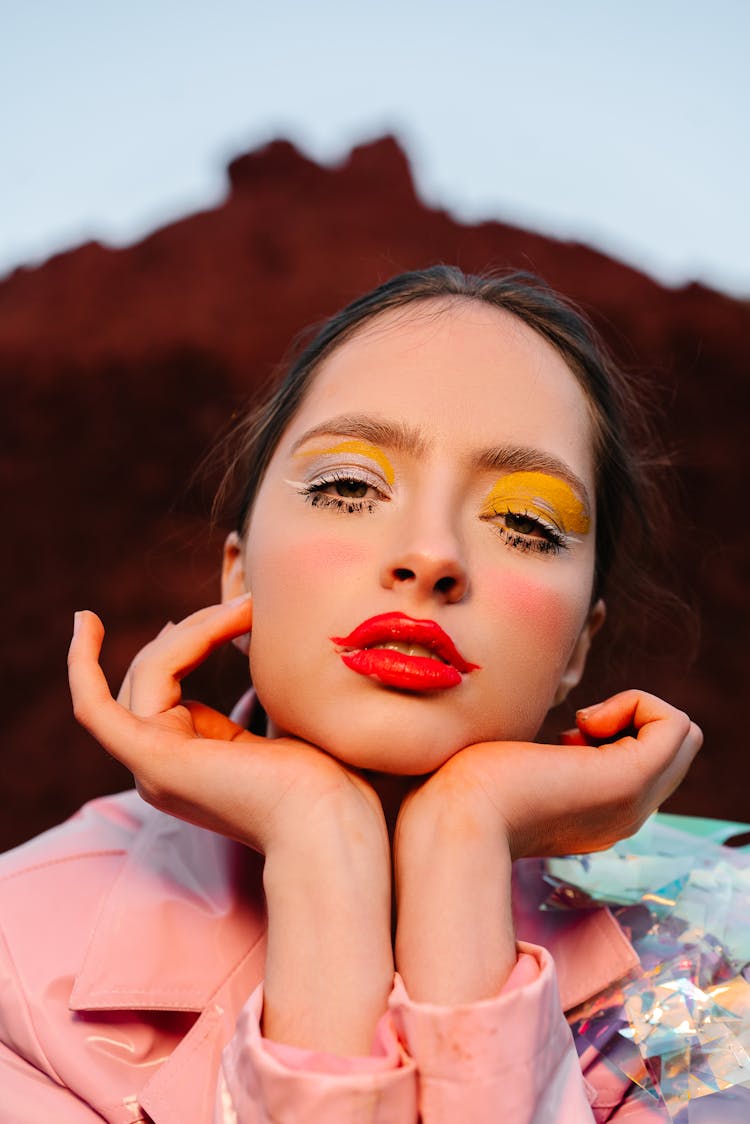 A Woman Posing With Her Hands On Chin