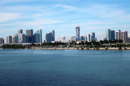 Free Miami Beach skyline featuring modern skyscrapers and a serene waterfront under a blue sky. Stock Photo