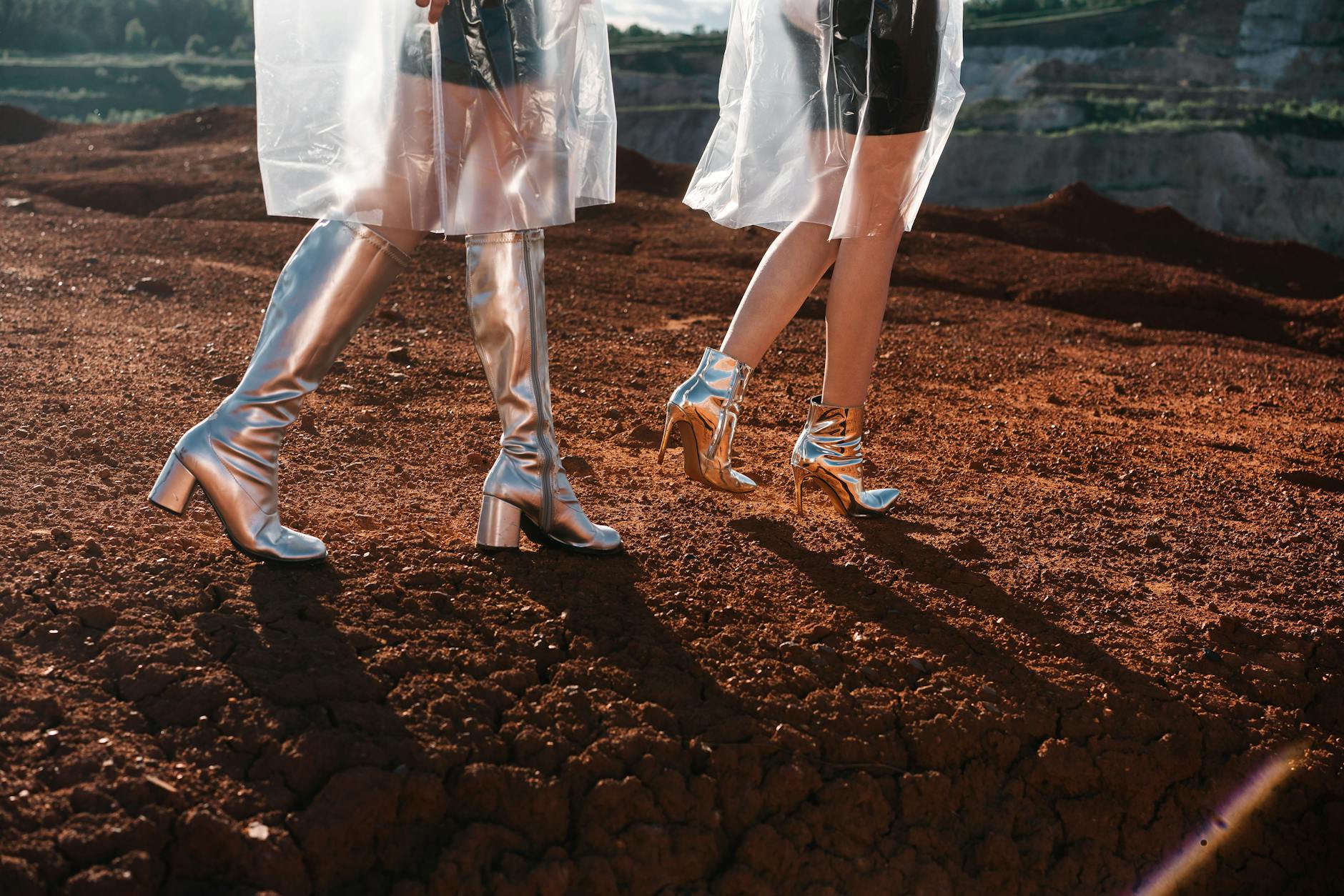 Knee Level Shot of Women in Trendy Outfits and Silver Boots