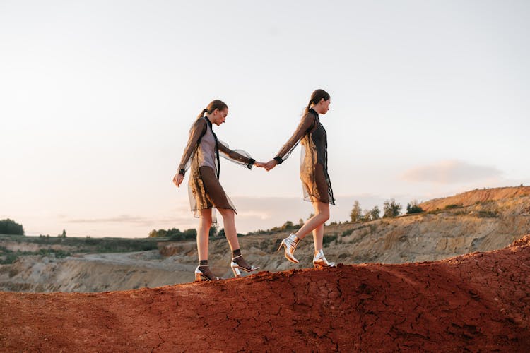 Women Walking On Brown Soil