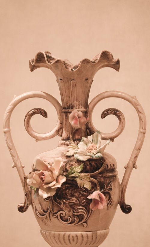 Free Elegant ornate vase with intricate floral design in sepia tone, perfect for home decor themes. Stock Photo