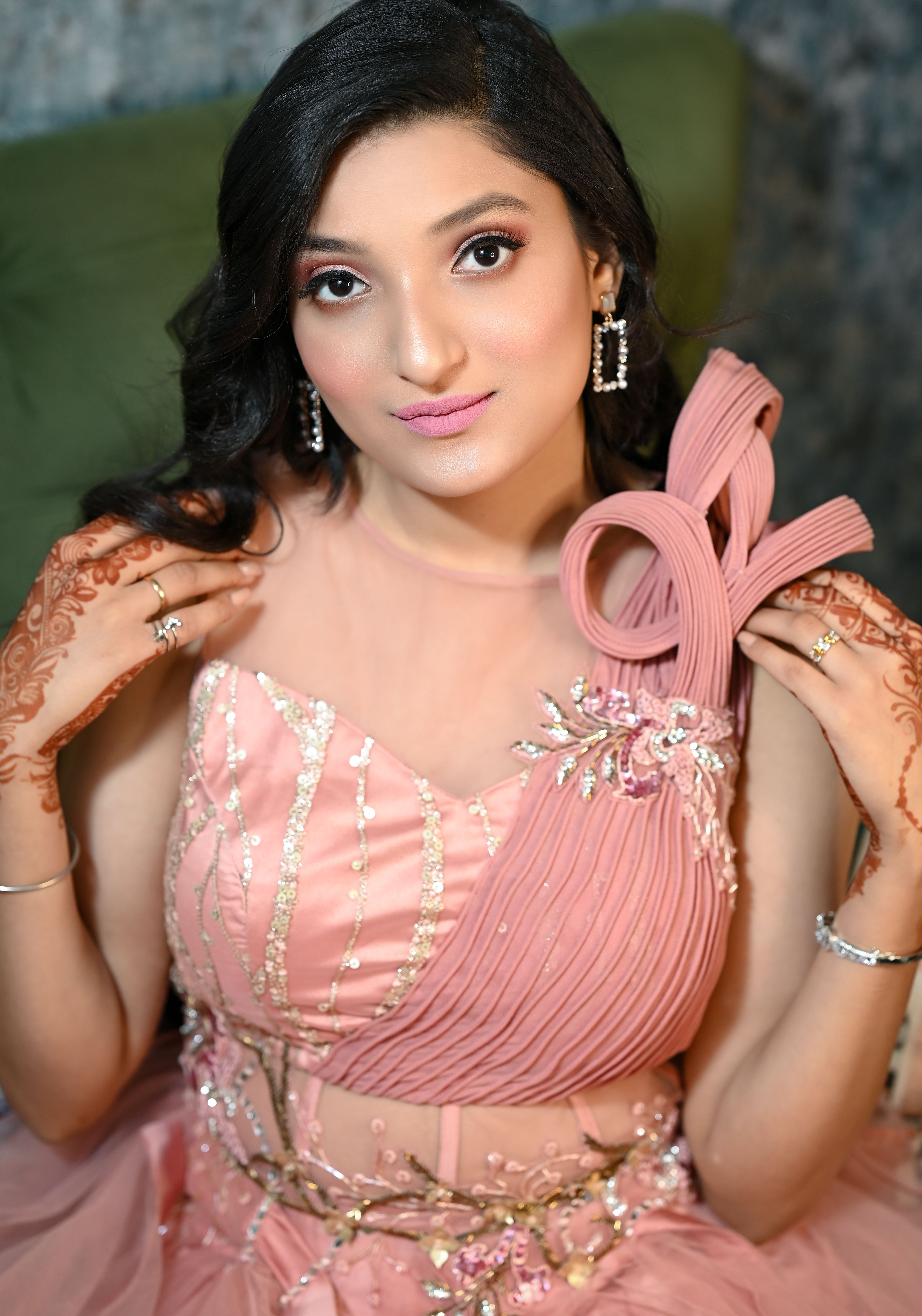 Chic portrait of a young woman showcasing elegance in a pink dress.