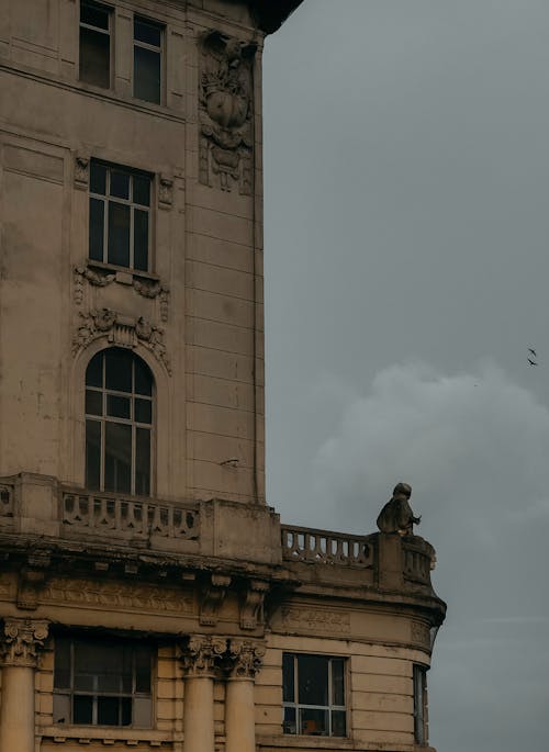 Brown Concrete Building Under White Clouds