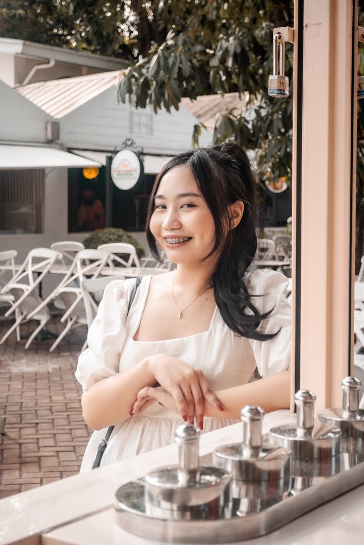 Woman In White Dress Standing On The Counter Of The Store