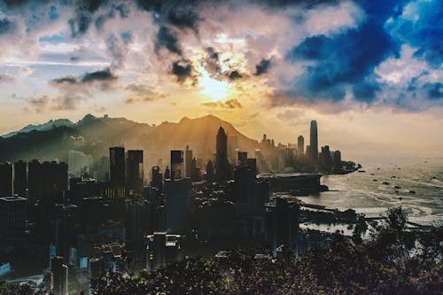 Bird's Eye View of City Near Ocean During Sunset