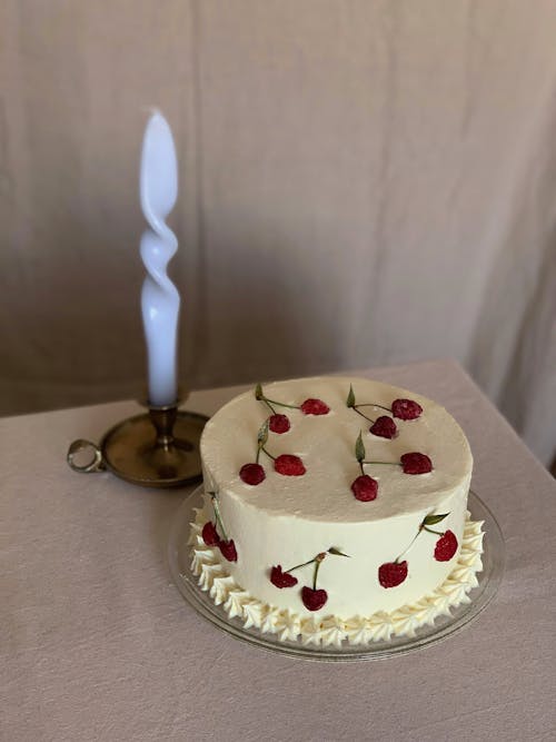 Delicious cake with berries near candle