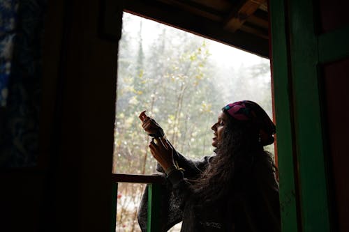 Woman Looking Outside the Window