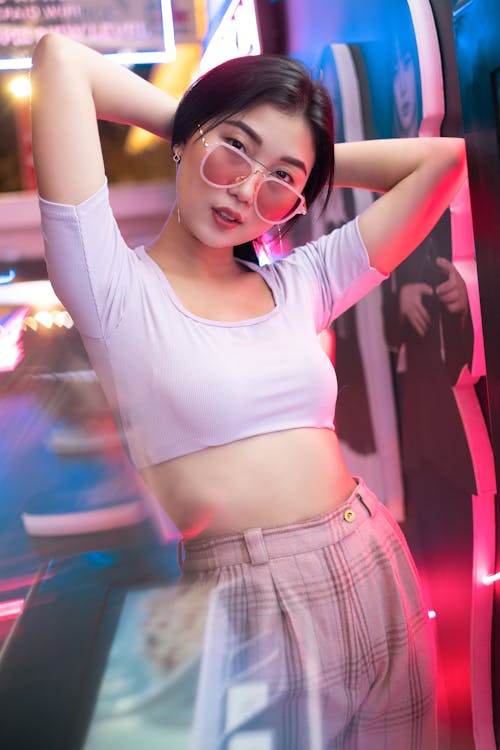 A Woman Wearing Sunglasses and a Crop Top 