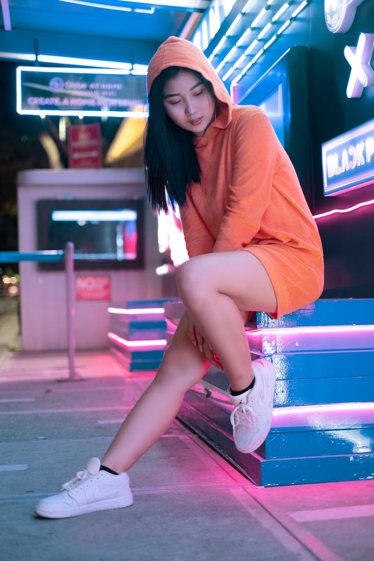 Woman In An Orange Hoodie Posing