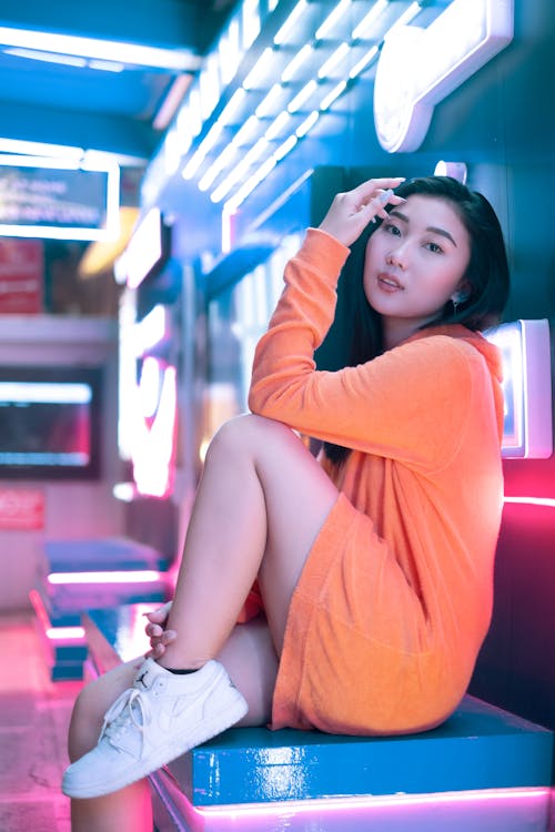 A Woman Posing Near Neon Lights