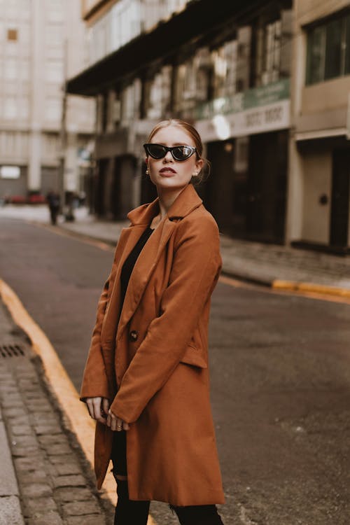 A Woman in a Coat Wearing Sunglasses